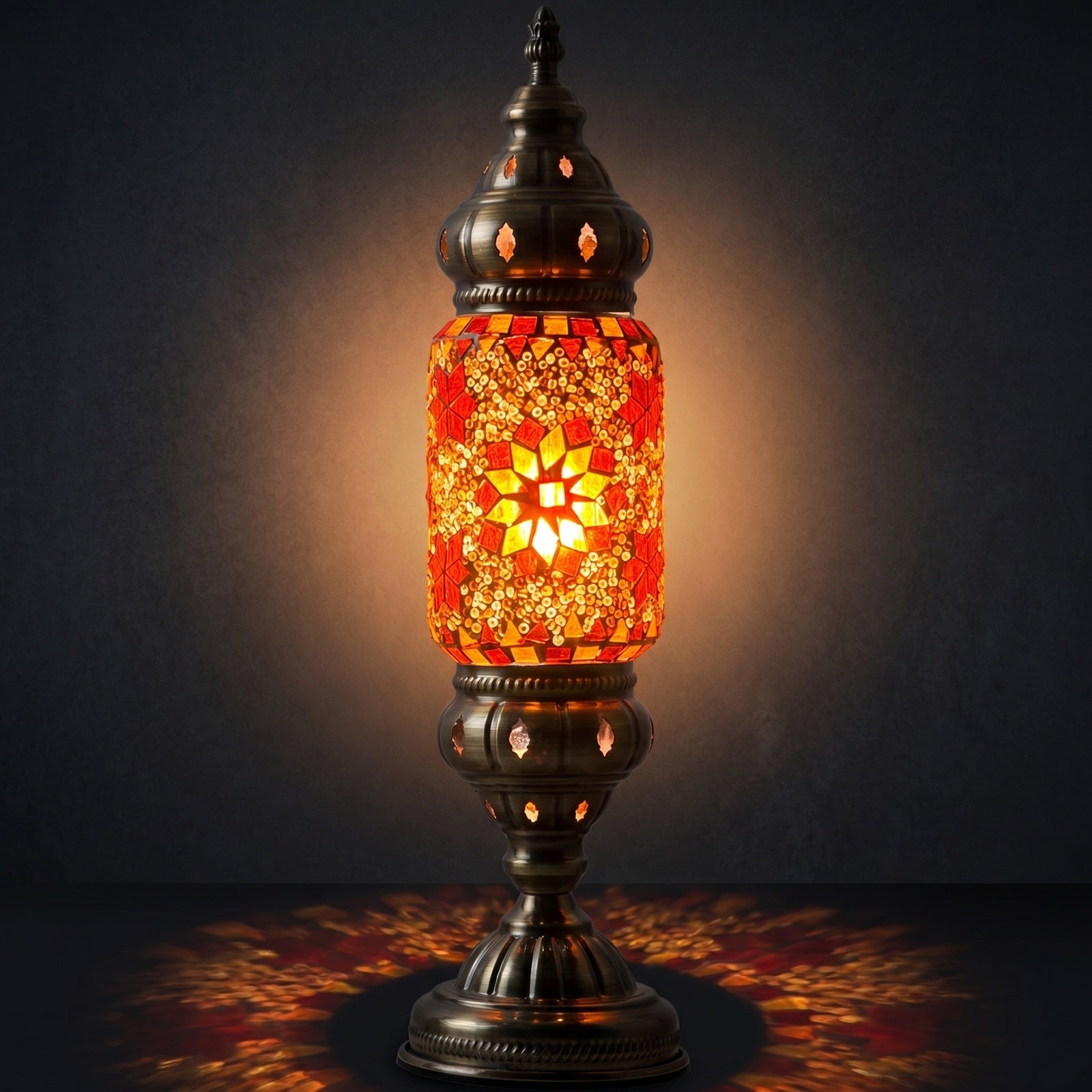 Mediterranean Allure mosaic glass table lamp — glowing against a deep charcoal background
