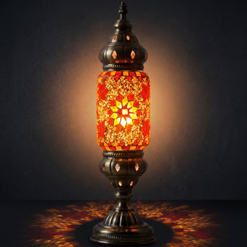 Mediterranean Allure mosaic glass table lamp — glowing against a deep charcoal background