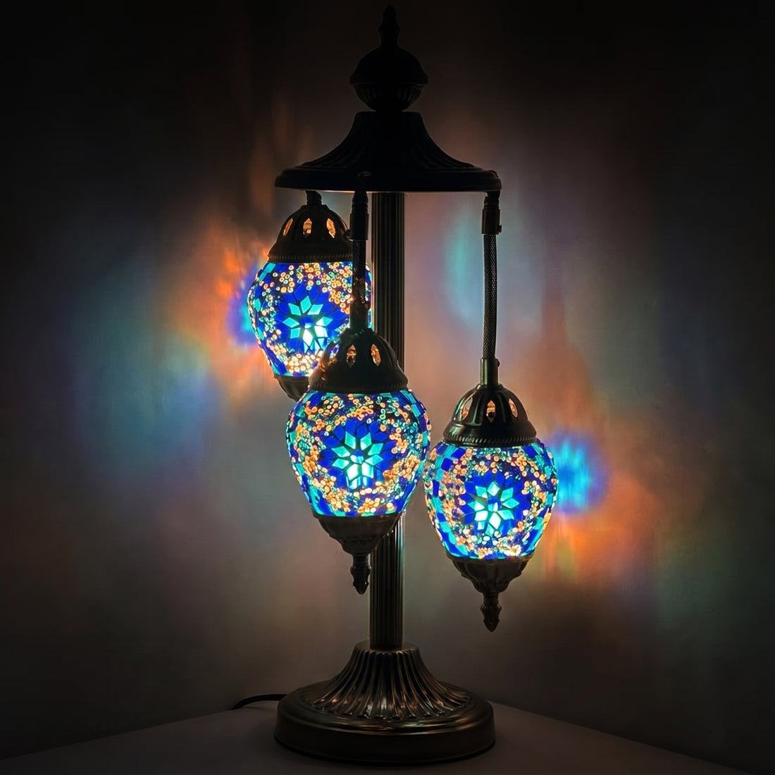 Midnight Blue Cosmos Egg mosaic glass table lamp — glowing against a deep charcoal background