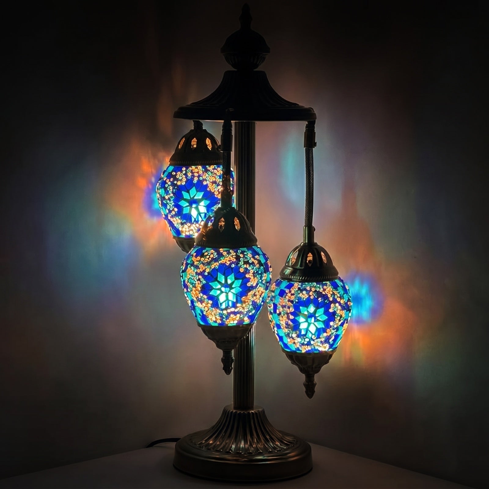 Midnight Blue Cosmos Egg mosaic glass table lamp — glowing against a deep charcoal background