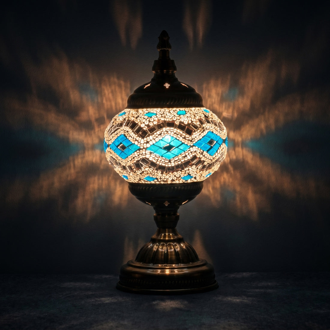 Moonlit Silver Blue mosaic glass table lamp — glowing against a deep charcoal background