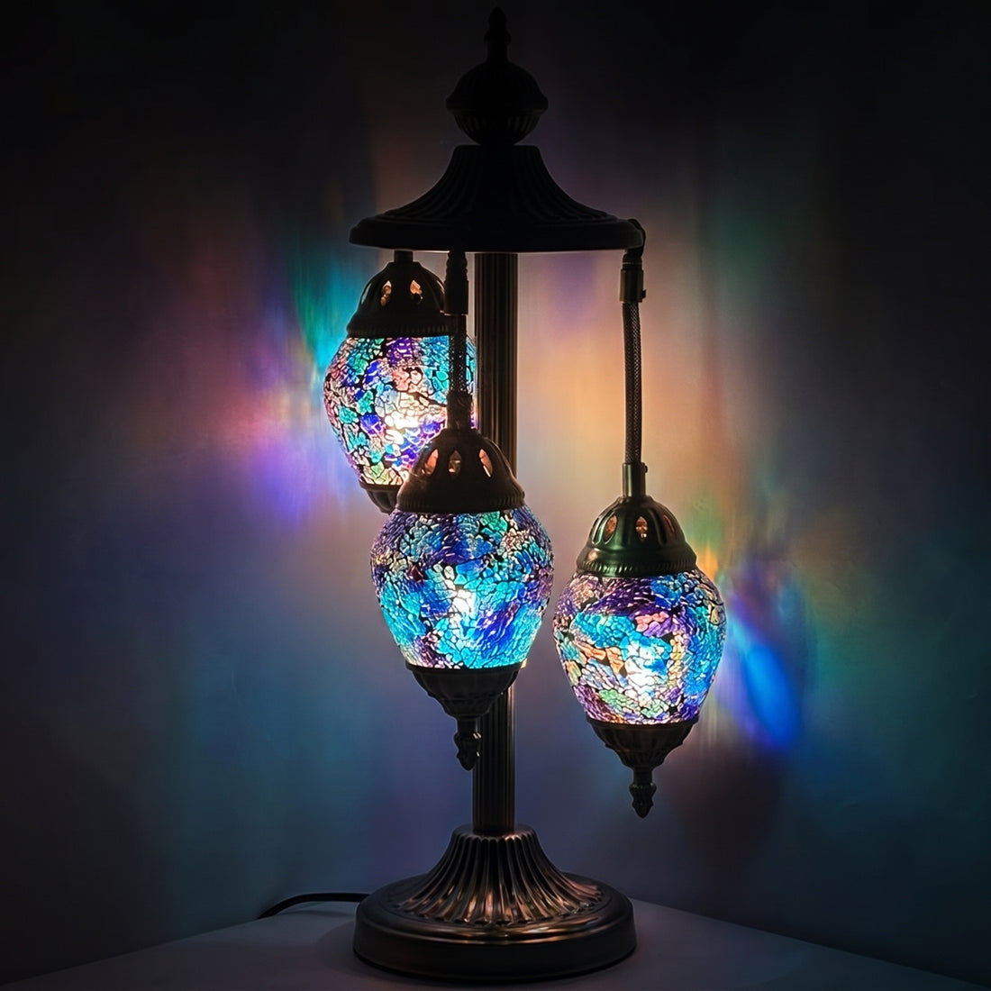 Nautical Navy Blue mosaic glass table lamp — glowing against a deep charcoal background