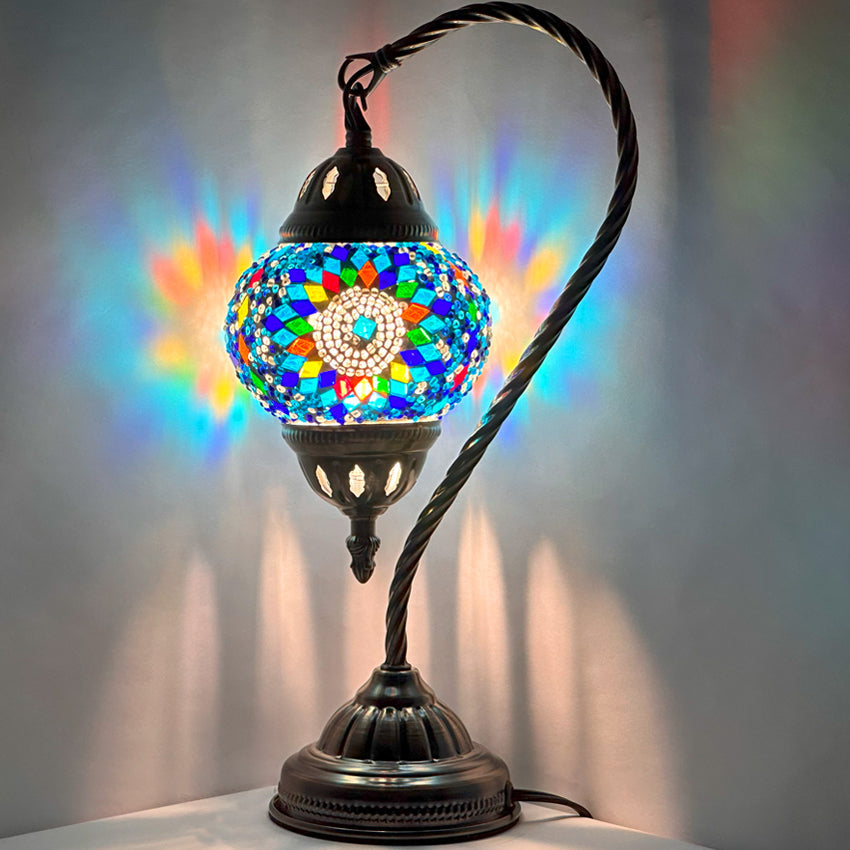 Blue Flower Turkish Style Lamps with Swan Neck Design mosaic glass table lamp — glowing against a dark background