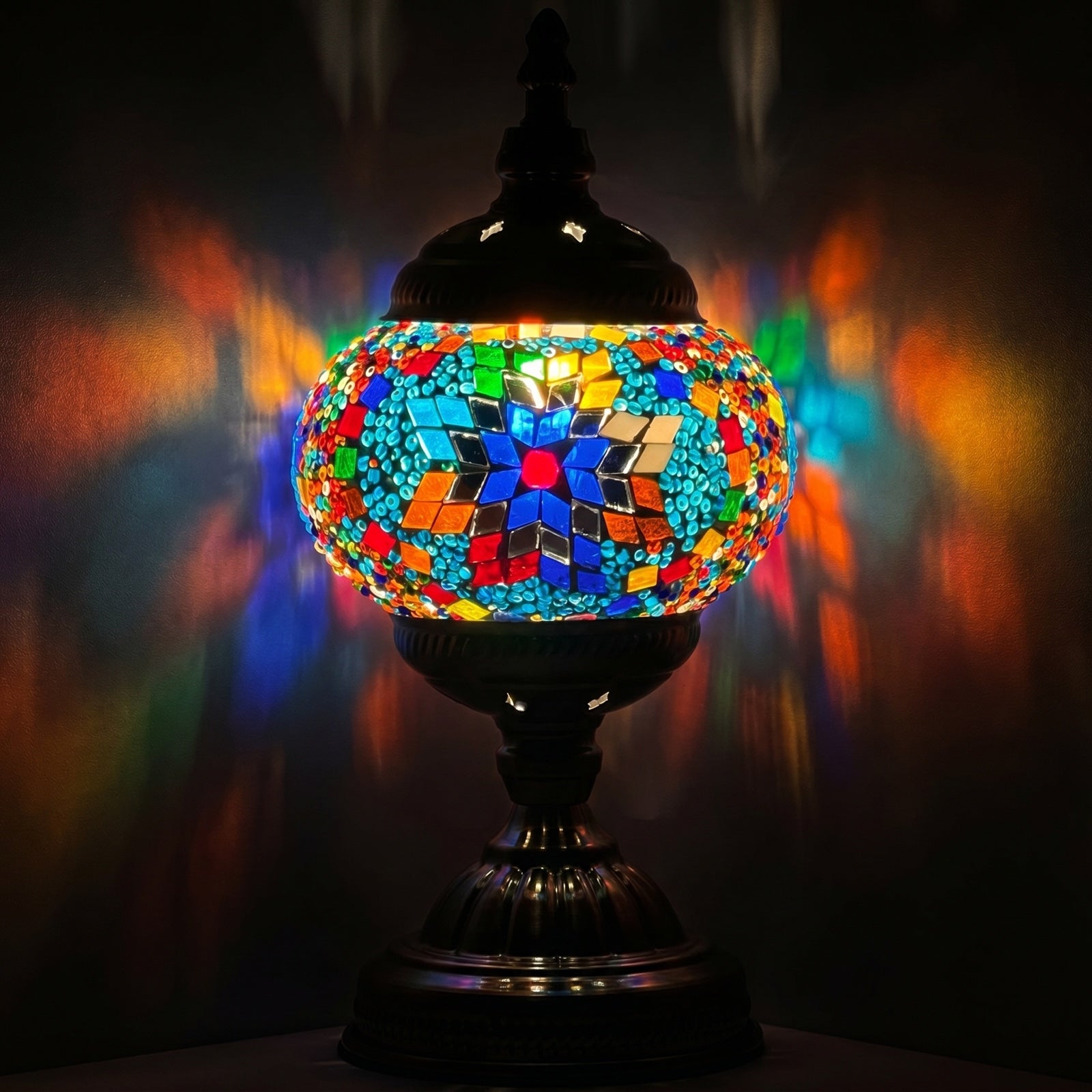 Prismatic Artistry mosaic glass table lamp — glowing against a deep charcoal background