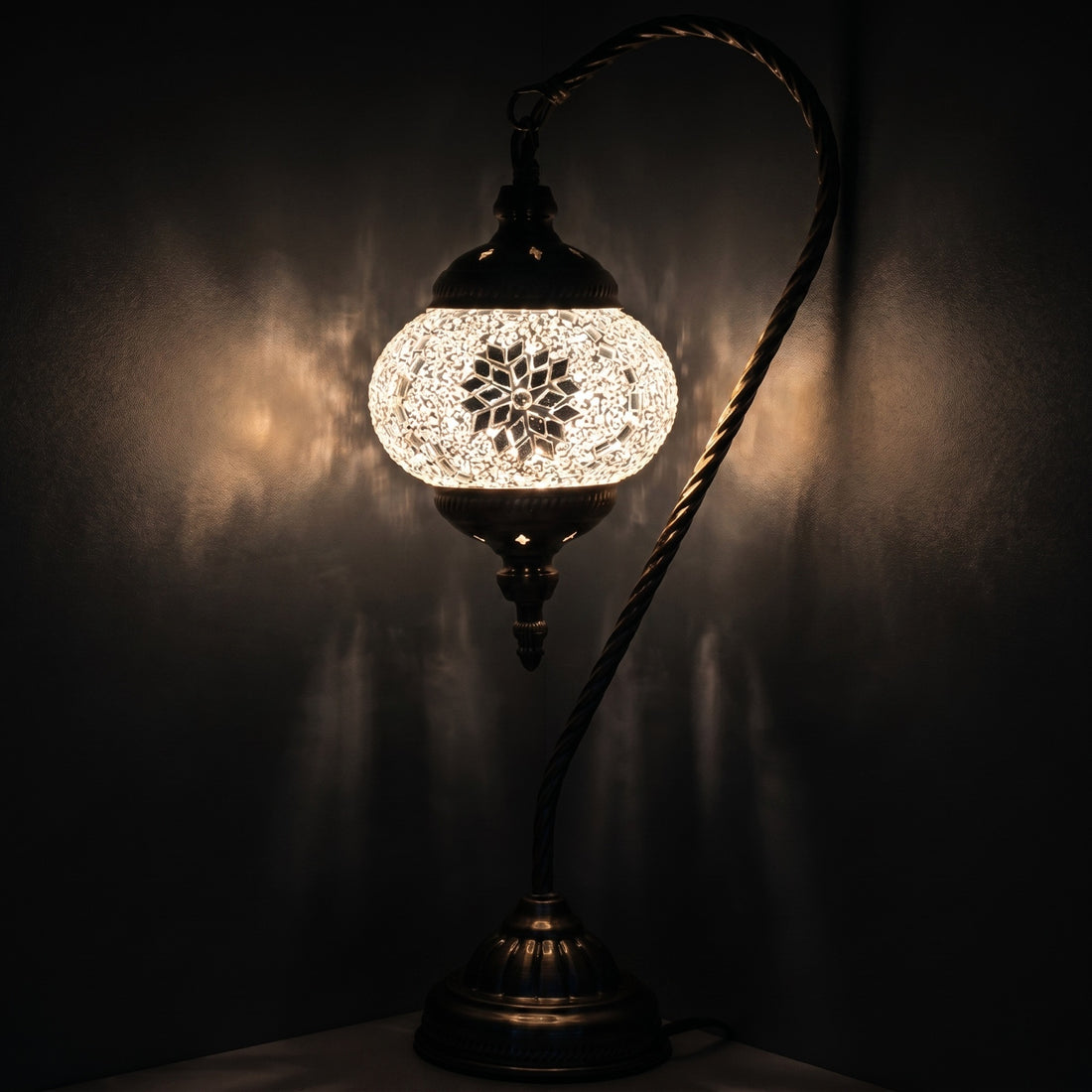 Purity Blossom mosaic glass table lamp — glowing against a deep charcoal background