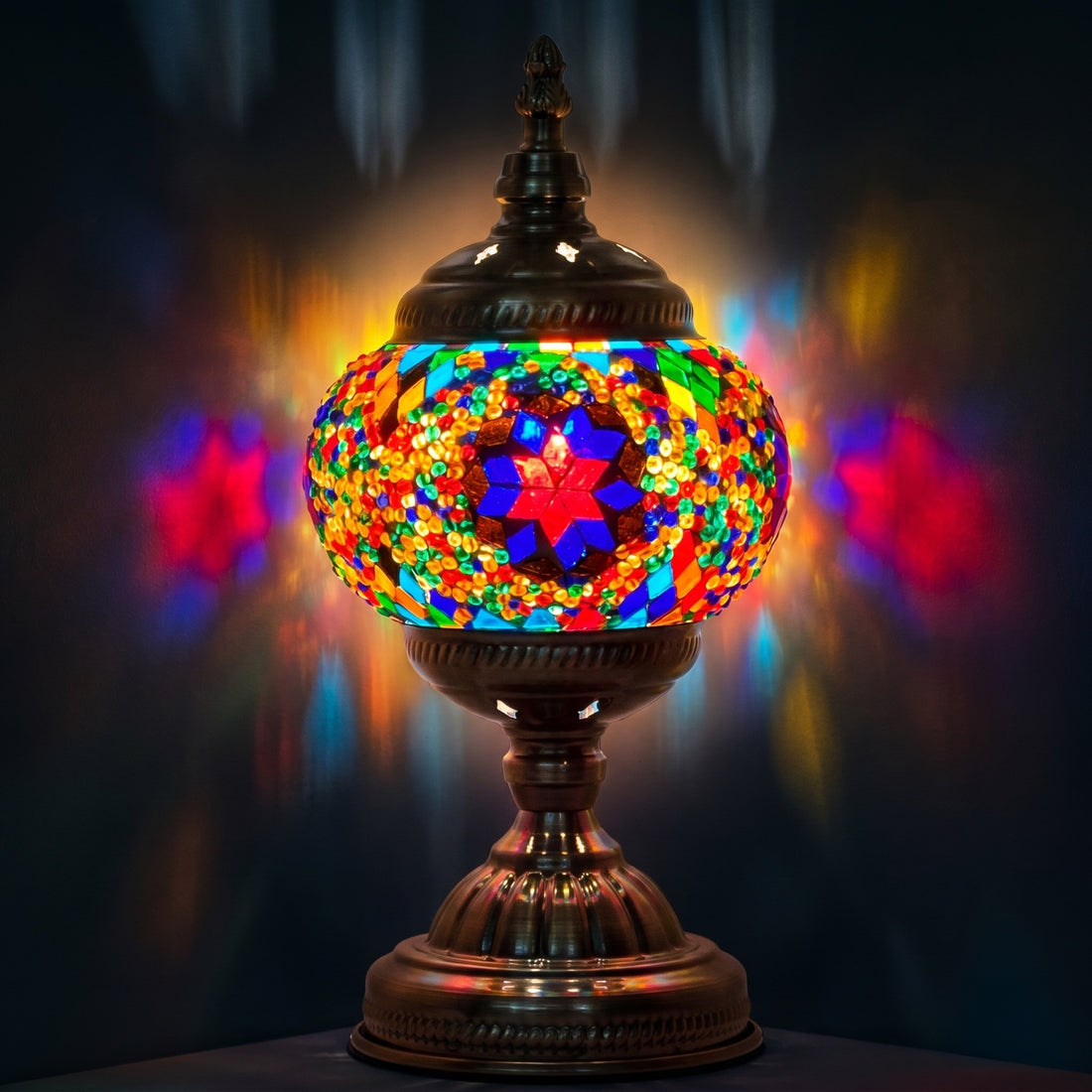 Purple Aurora mosaic glass table lamp — glowing against a deep charcoal background