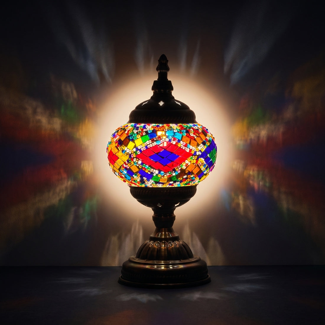Rainbow Harmony mosaic glass table lamp — glowing against a deep charcoal background