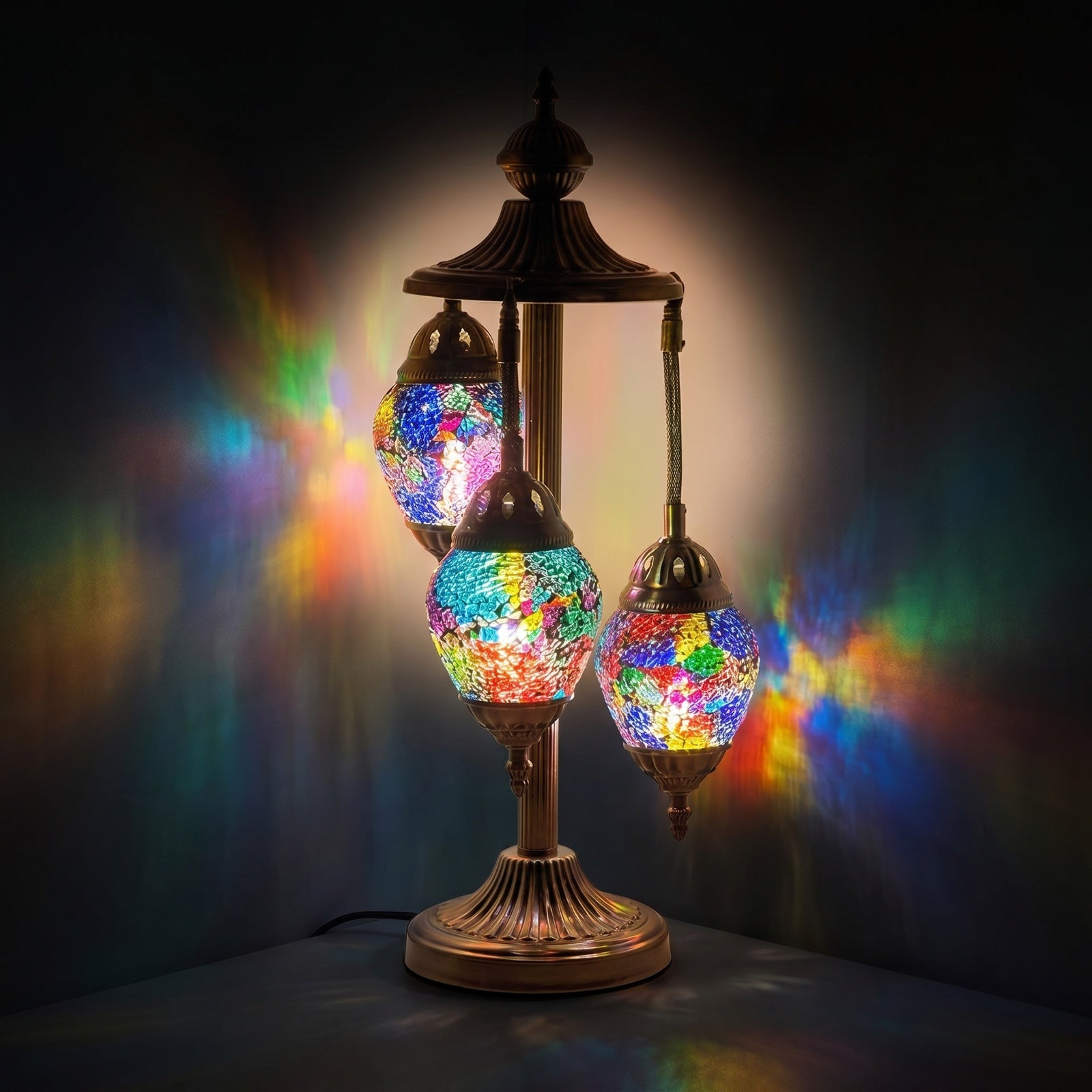 Rainbow Spectrum Egg mosaic glass table lamp — glowing against a deep charcoal background