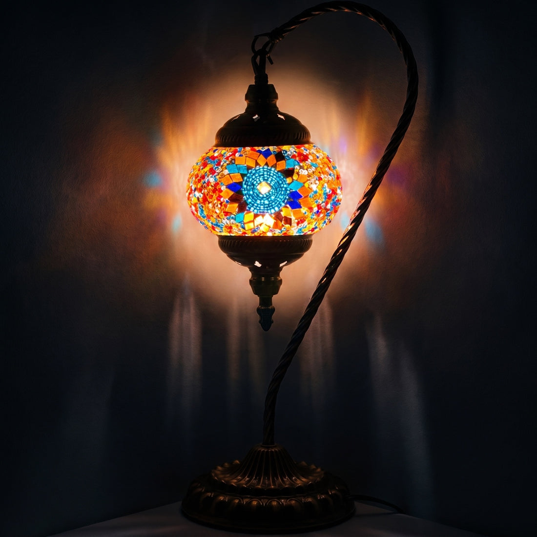 Scarlet Sunflower mosaic glass table lamp — glowing against a deep charcoal background