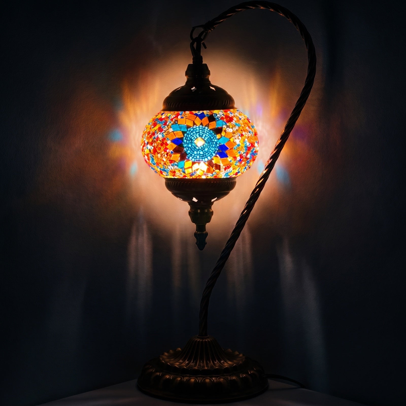 Scarlet Sunflower mosaic glass table lamp — glowing against a deep charcoal background