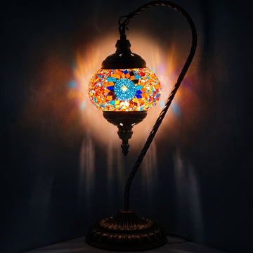 Scarlet Sunflower mosaic glass table lamp — glowing against a deep charcoal background