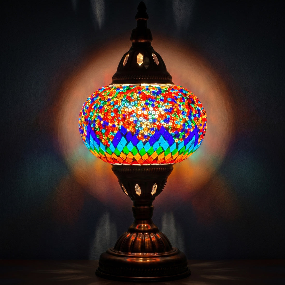 Spectrum Harmony mosaic glass table lamp — glowing against a deep charcoal background
