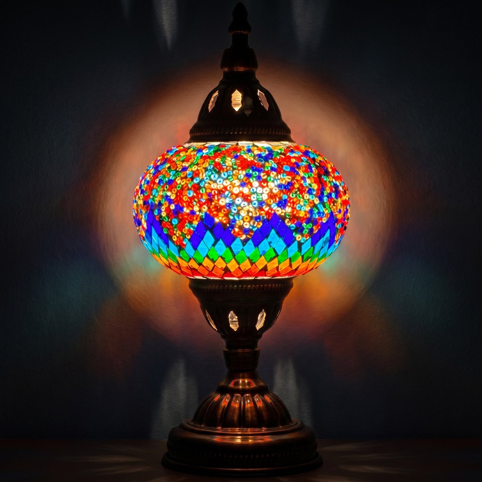 Spectrum Harmony mosaic glass table lamp — glowing against a deep charcoal background