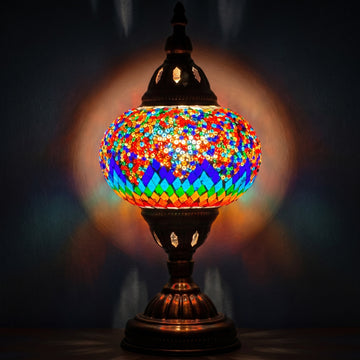 Spectrum Harmony mosaic glass table lamp — glowing against a deep charcoal background