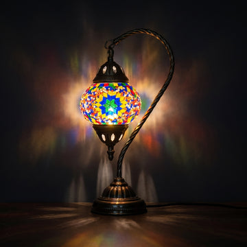 Sunbeam Glow mosaic glass table lamp — glowing against a deep charcoal background