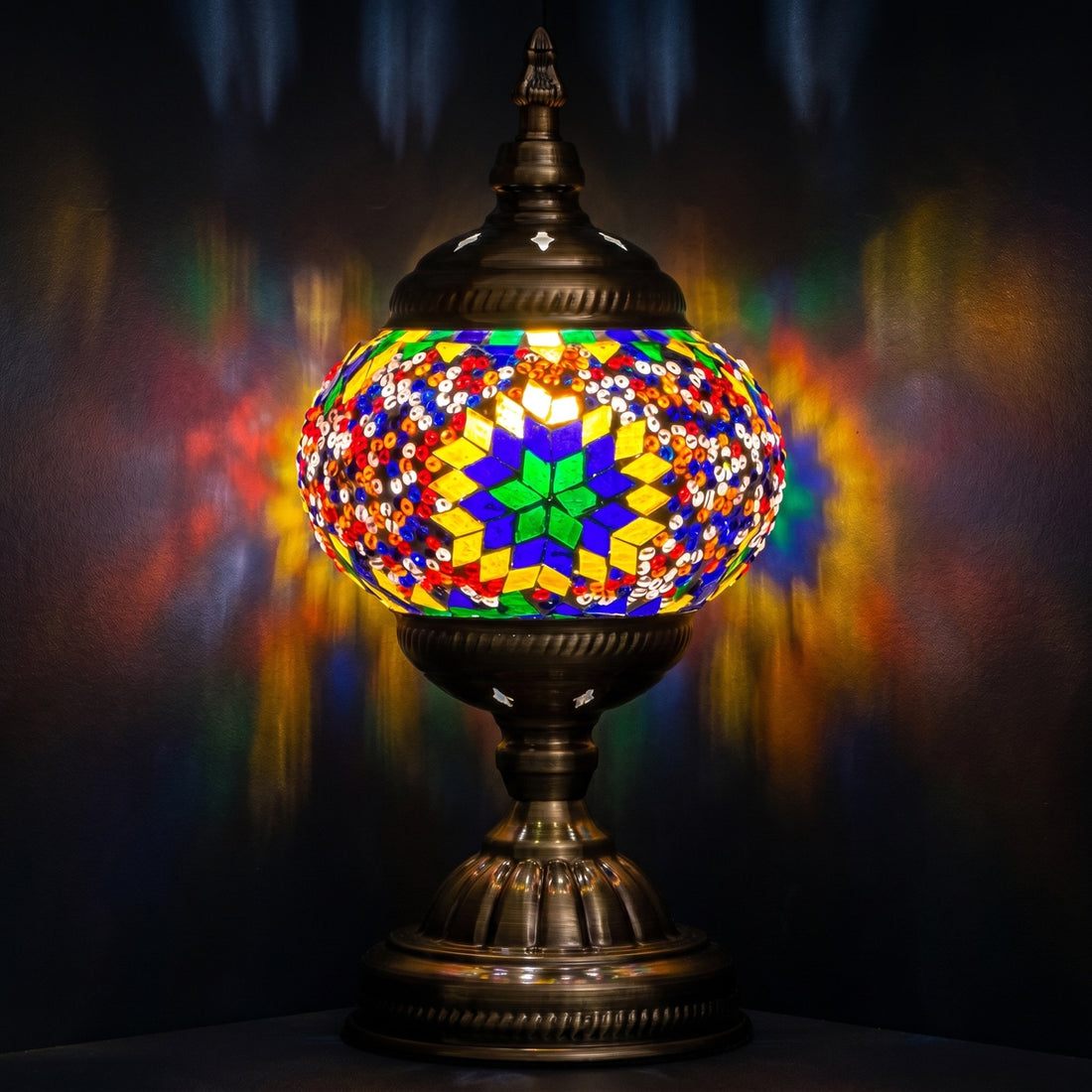 Sunset Aura mosaic glass table lamp — glowing against a deep charcoal background