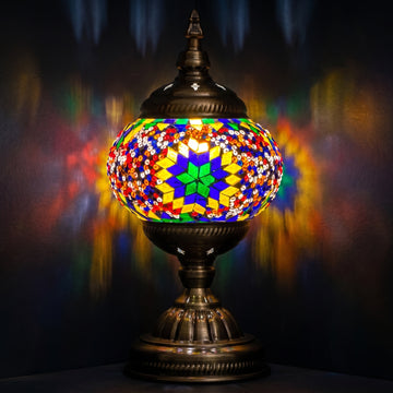 Sunset Aura mosaic glass table lamp — glowing against a deep charcoal background