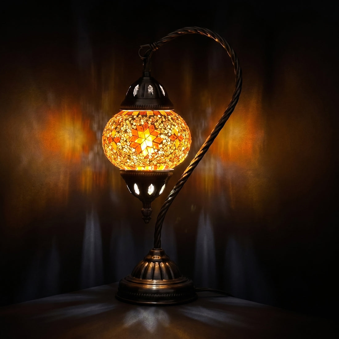 Sunset Glow mosaic glass table lamp — glowing against a deep charcoal background