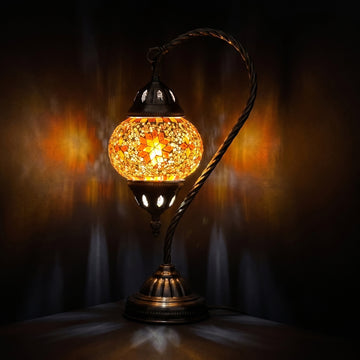Sunset Glow mosaic glass table lamp — glowing against a deep charcoal background