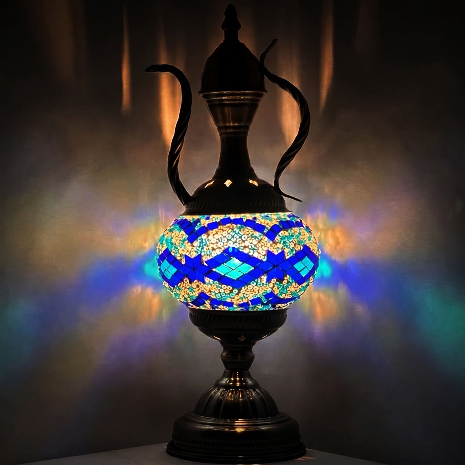 Tiffany mosaic glass table lamp — glowing against a deep charcoal background