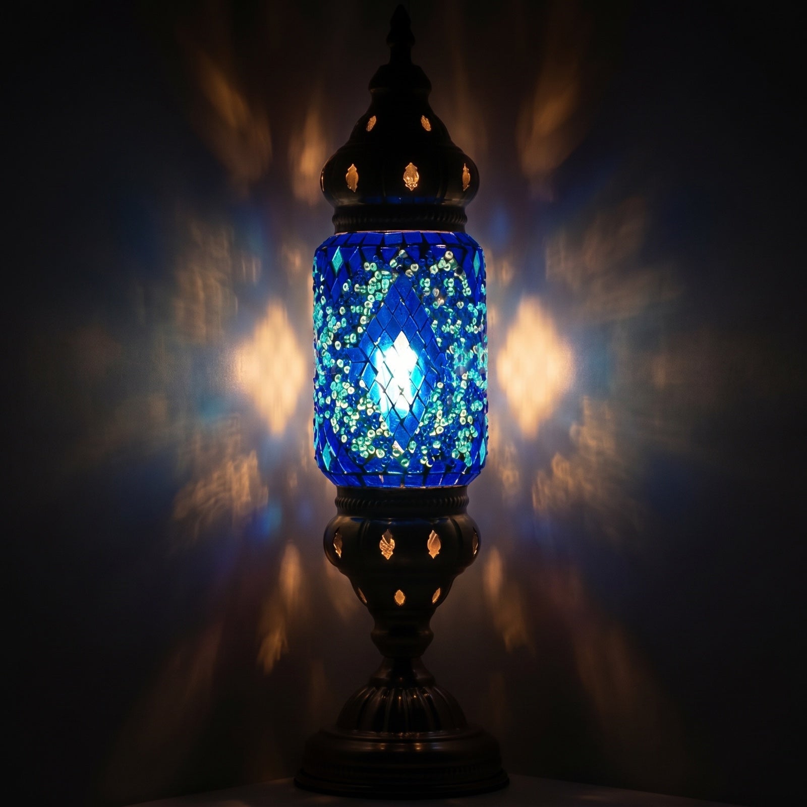 Turkish Blue Diamond Lamp mosaic glass table lamp — glowing against a deep charcoal background