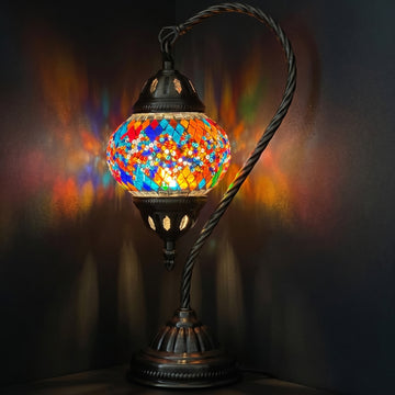 Twin Rainbow Bridge Mosaic Table Lamp with Swan Neck mosaic glass table lamp — glowing against a deep charcoal background