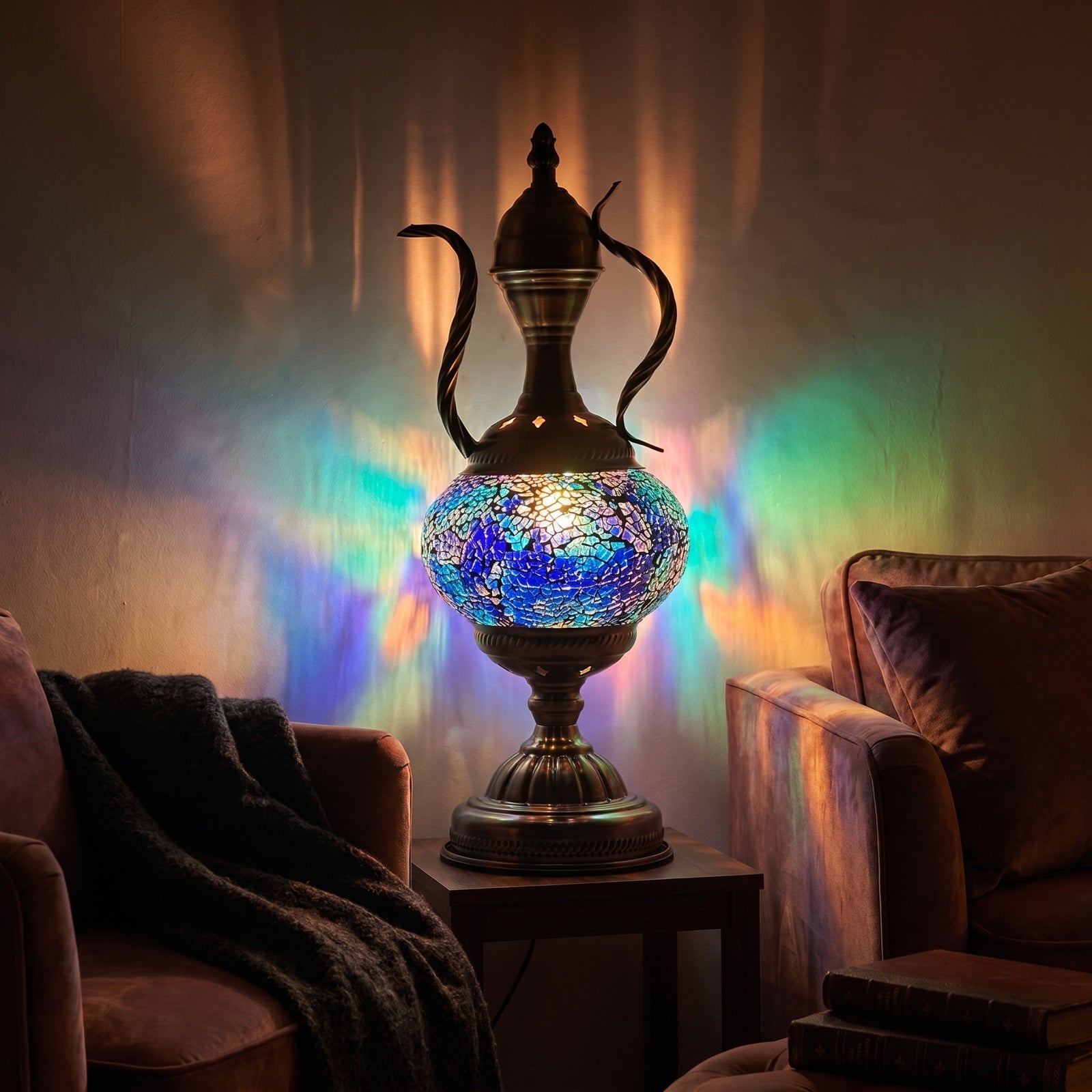 Mosaic glass ewer table lamp casting colorful light across a cozy evening living room setting