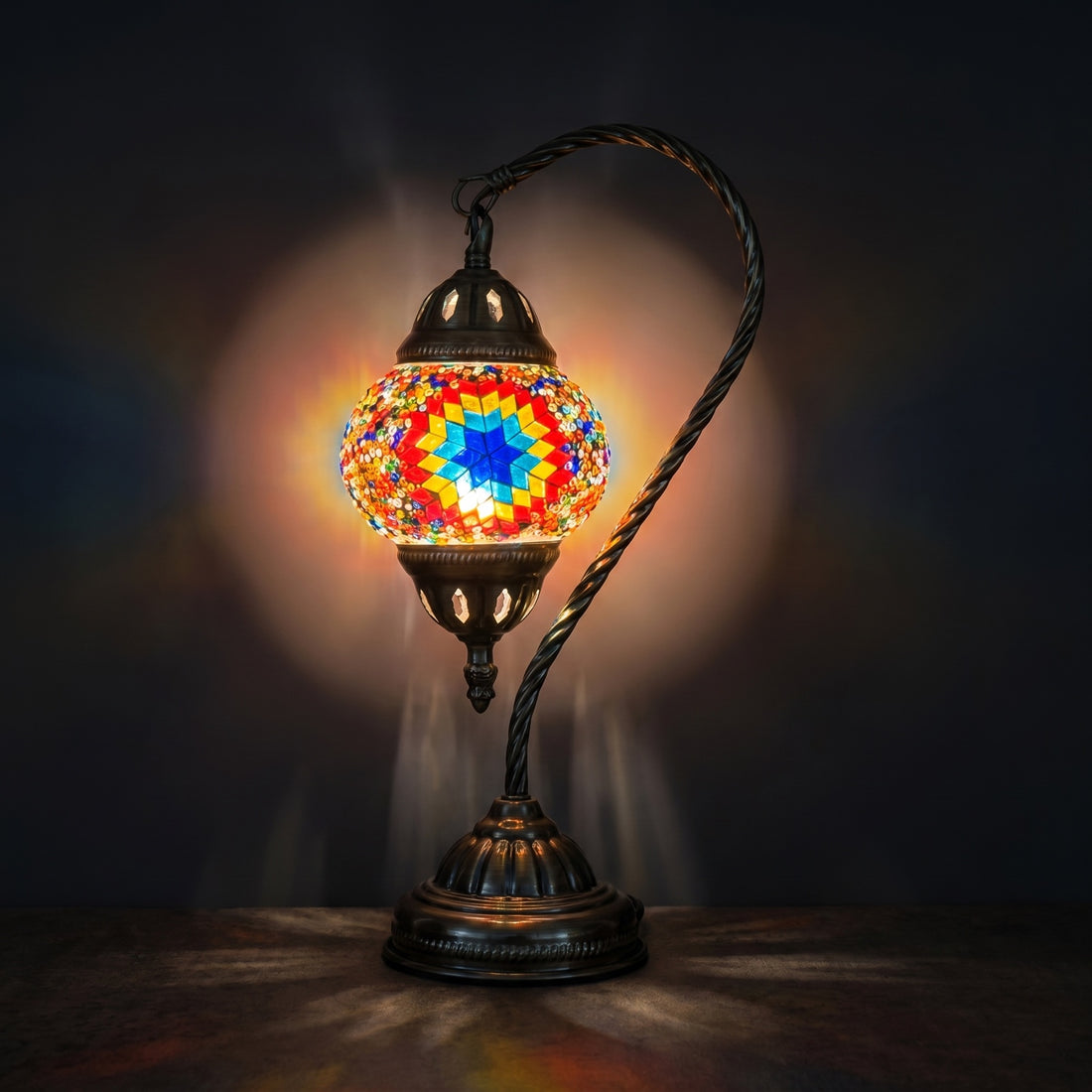 Vintage Mosaic Charm mosaic glass table lamp — glowing against a deep charcoal background