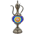 a metal vase with a colorful design on it