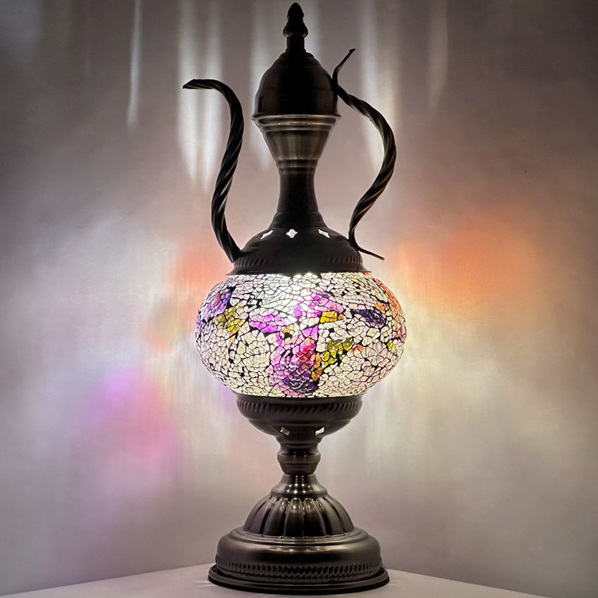 a black vase with a flowered design on it