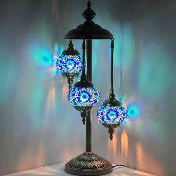 a table lamp with three lights on top of it
