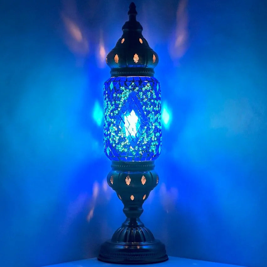 a blue lit up lamp on a table
