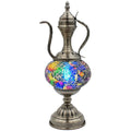 a silver vase with a colorful design on it