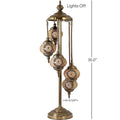 a brass colored lamp with four globes on it