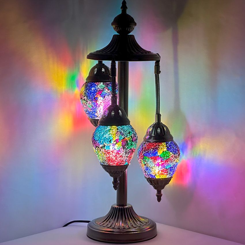 a multicolored lamp with three lights on top of it