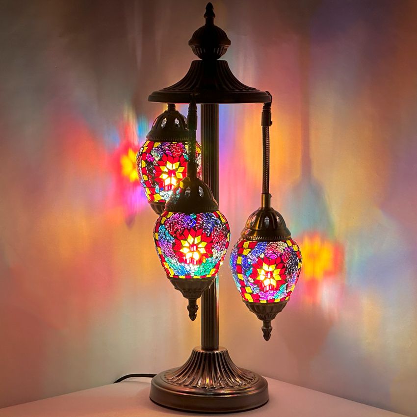 a lamp with three colorful lights on top of it