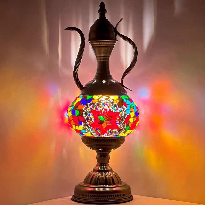 a stained glass vase sitting on top of a table