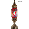 a lamp with a colorful glass shade on top of it